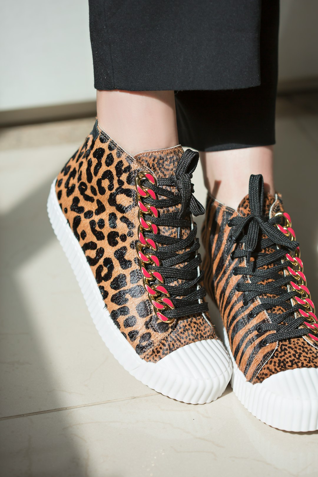 a close up of a person wearing leopard print sneakers