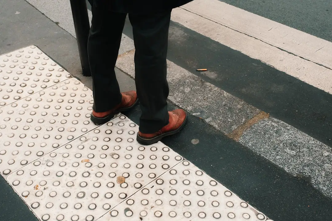 a person standing on a cross walk with their feet on the ground
