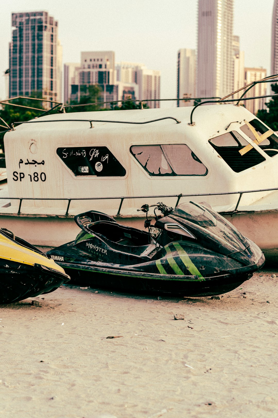 a couple of jet skis sitting on top of a sandy beach