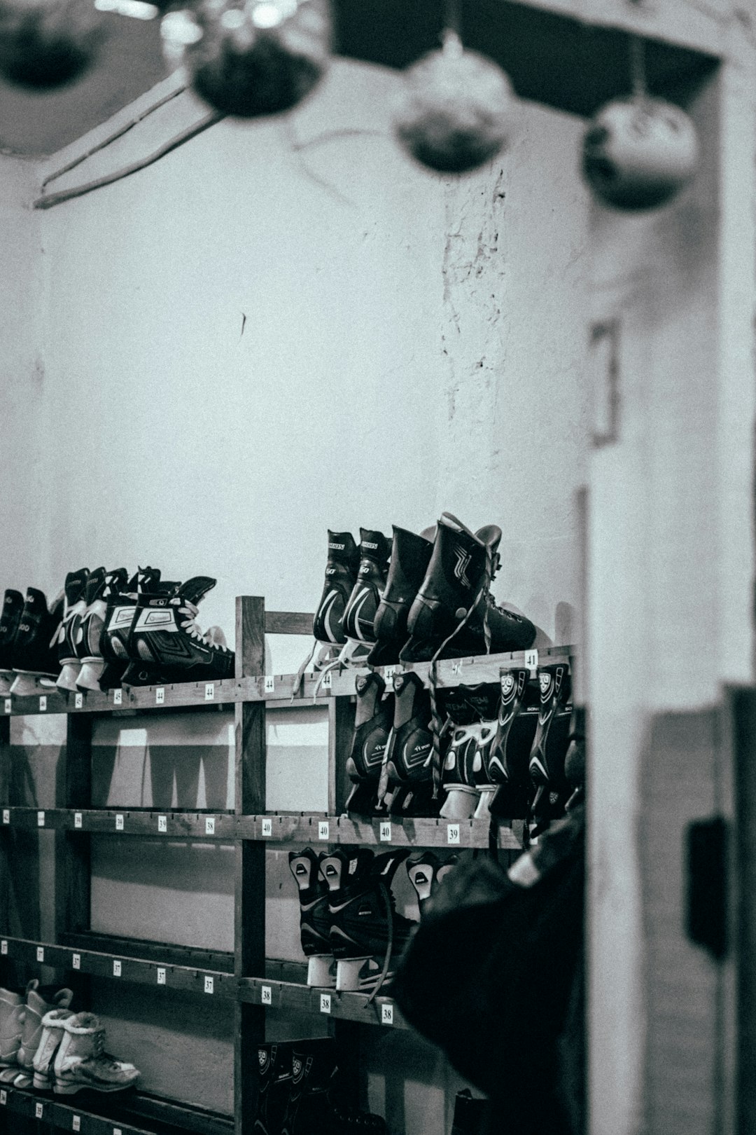 👟 The Soleful Journey: A Brief History of Footwear Giants by Shoe Brands shoes on rack in grayscale photography