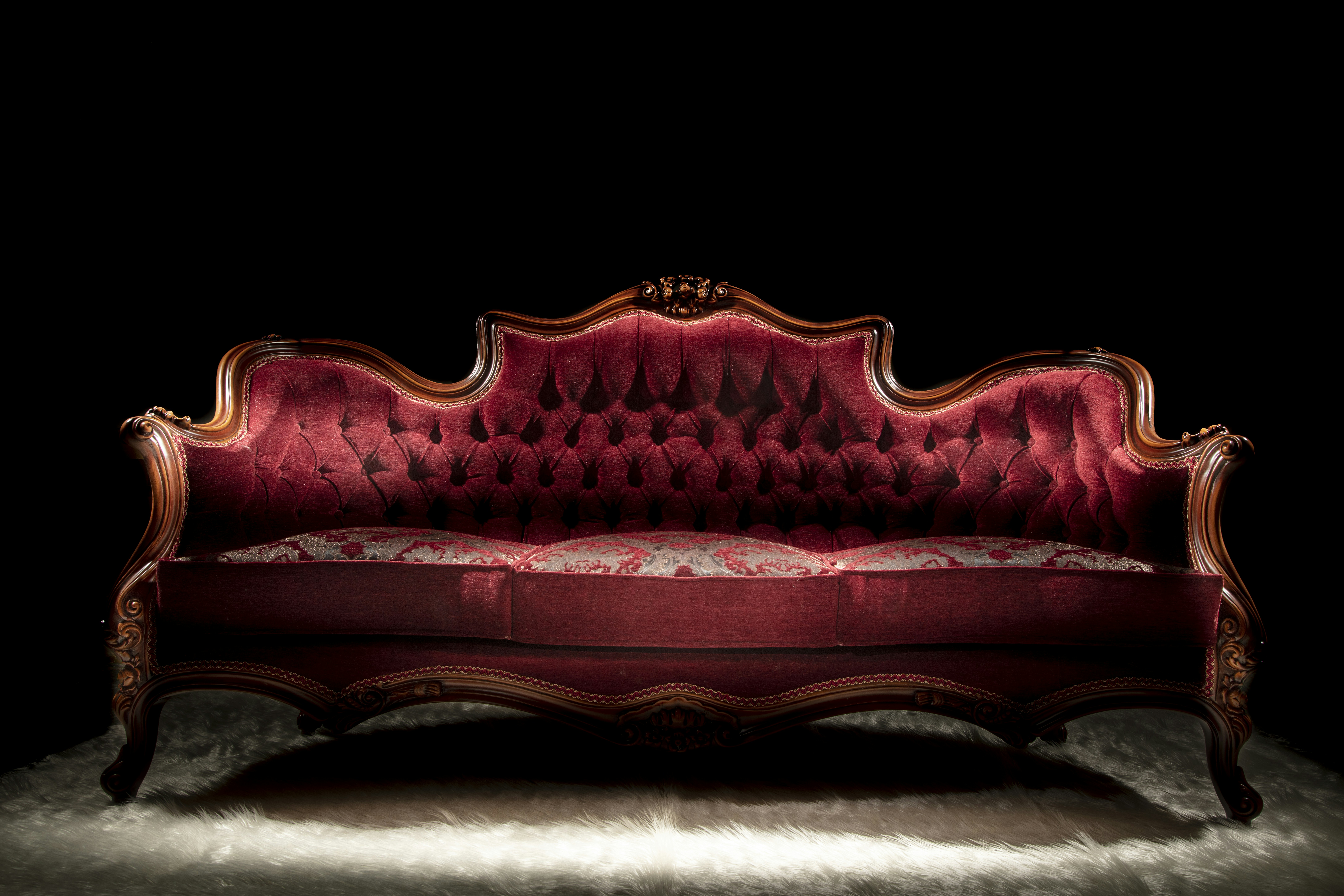 a red couch with a black background